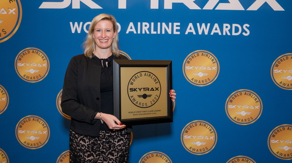 person standing on stage with award.