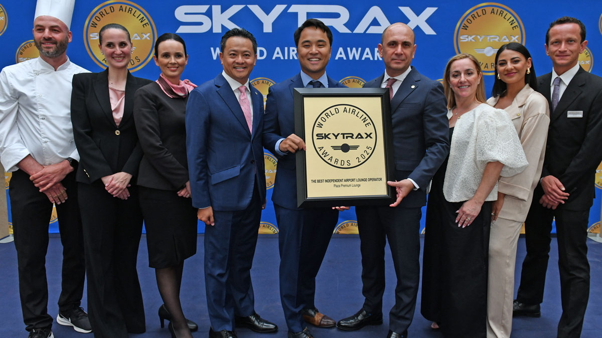 Nine people standing on stage to accept an award for the Best Independent Lounge award.