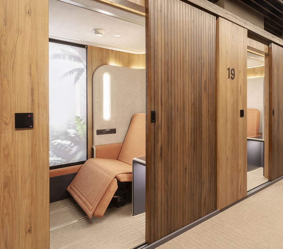 Sleepover lounge, Flexisuite room with reclining chair and privacy door.