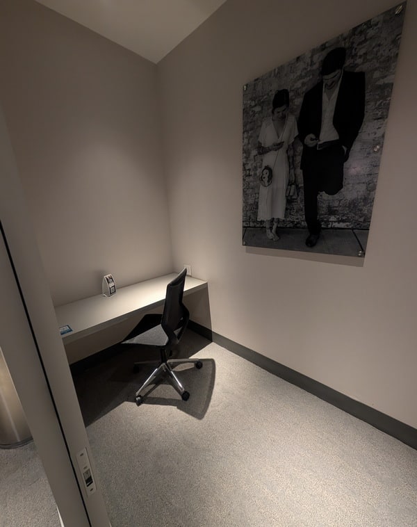 soundproof room with desk and closing door.