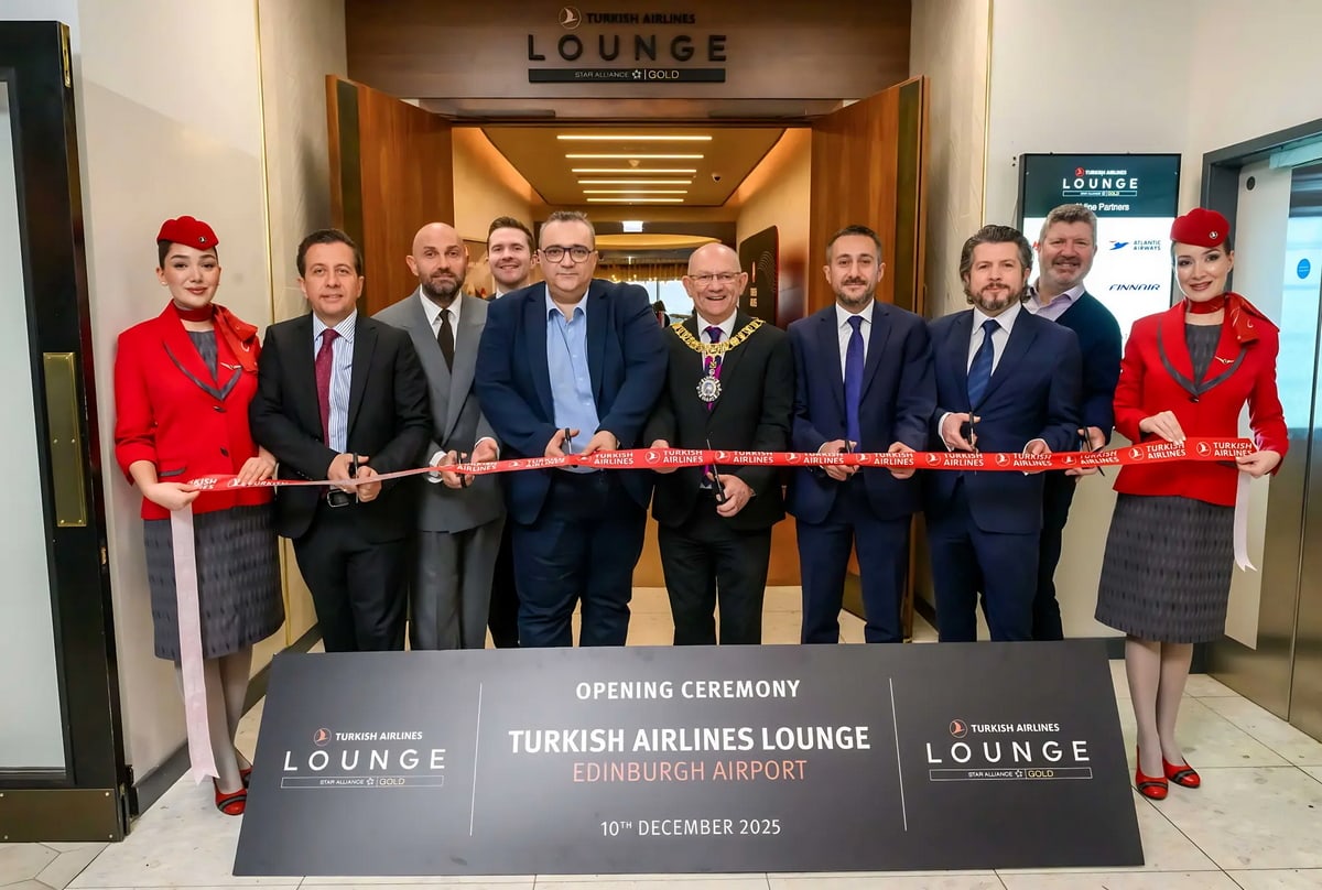 People doing a ribbon cutting at in front of the Turkish Airlines lounge.