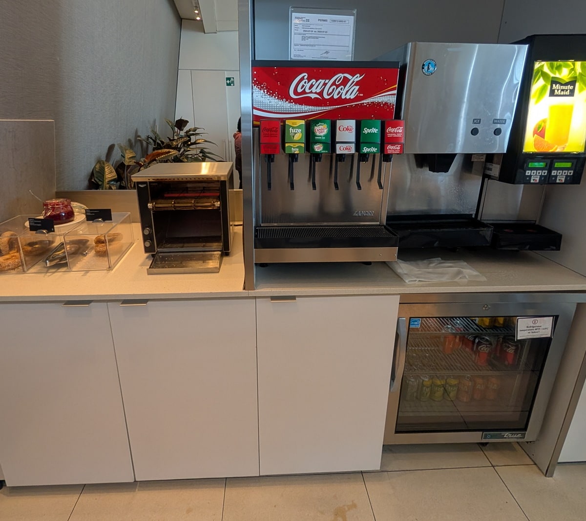 self-serve beverage station, with soda and canned drinks.