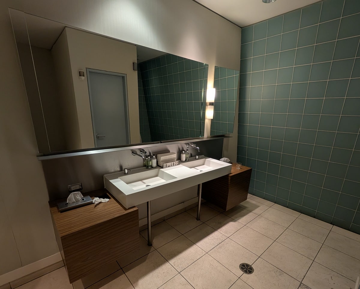 mens restroom sink and mirror.