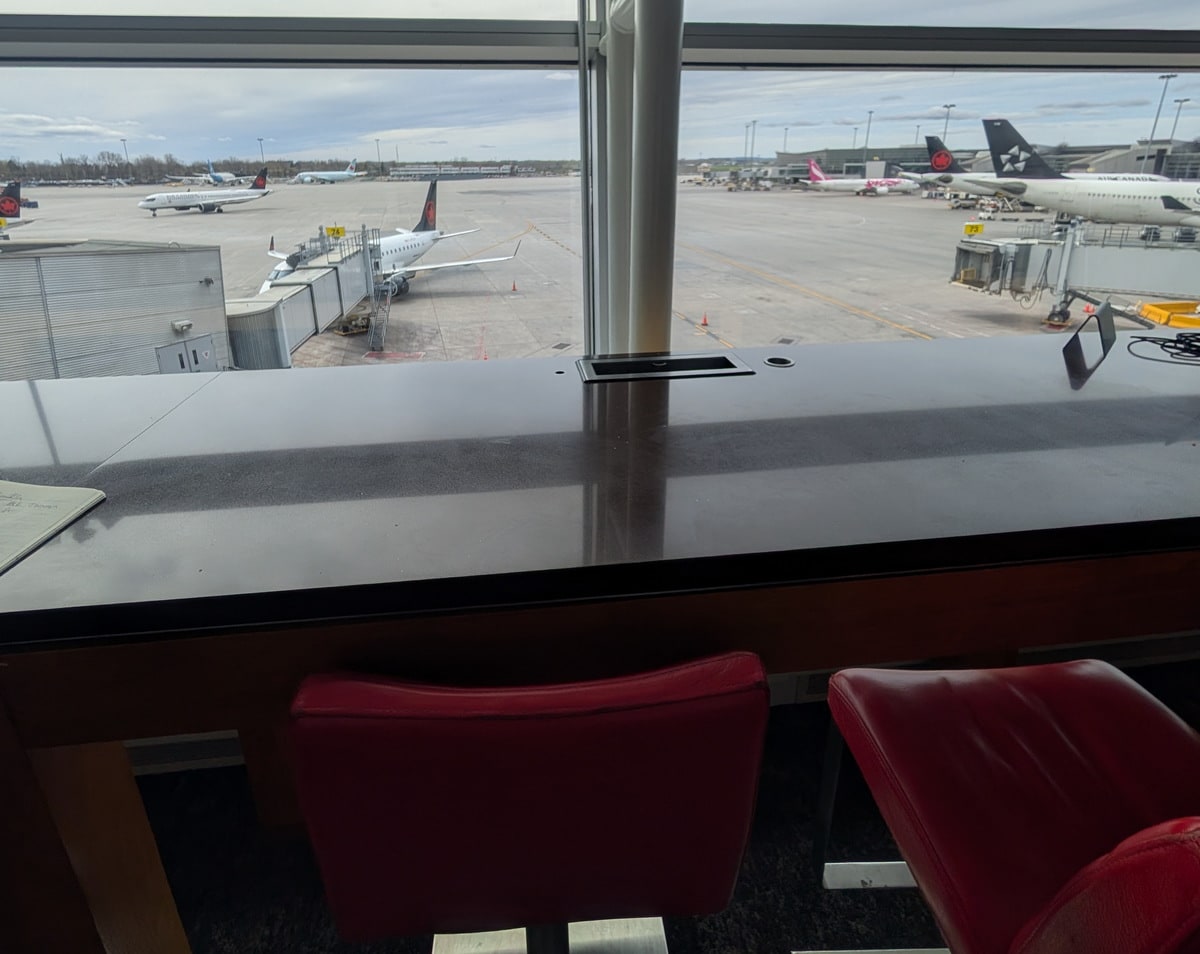 window seating with chairs and table, and a view outside.