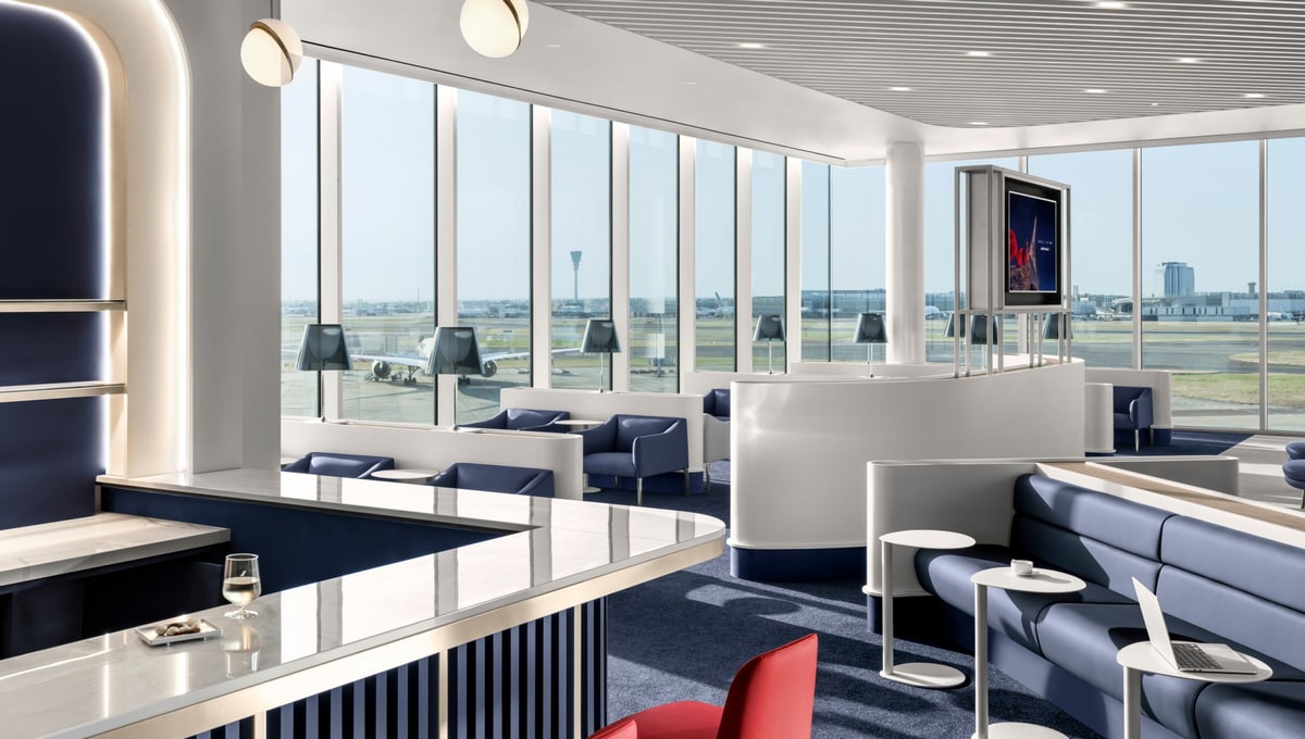 main seating area, with bar, small tables, and large floor-to-ceiling windows.