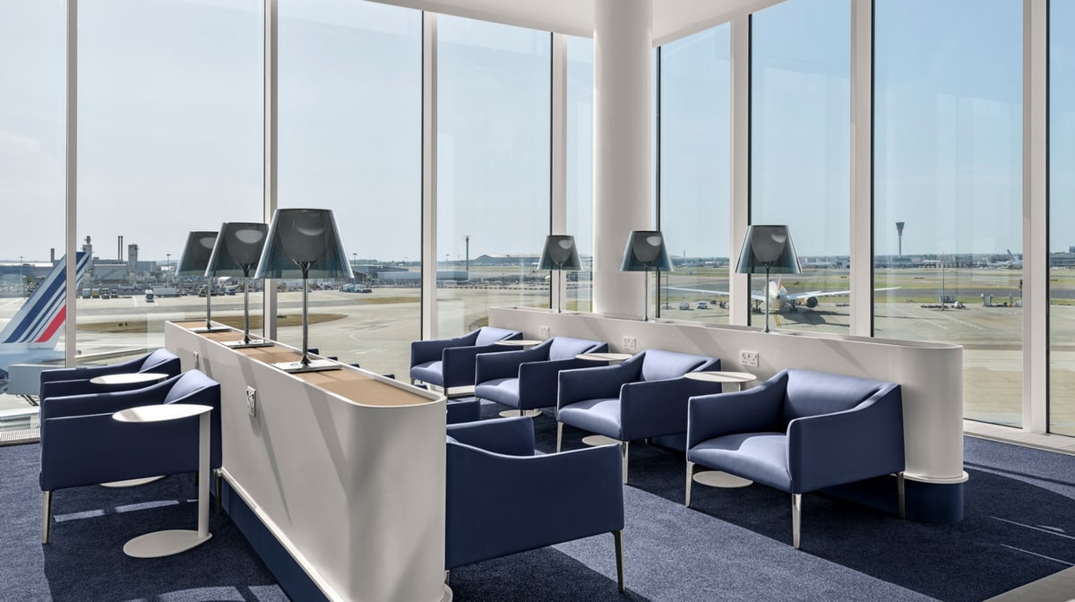 charis and small side tables with large windows in the background.