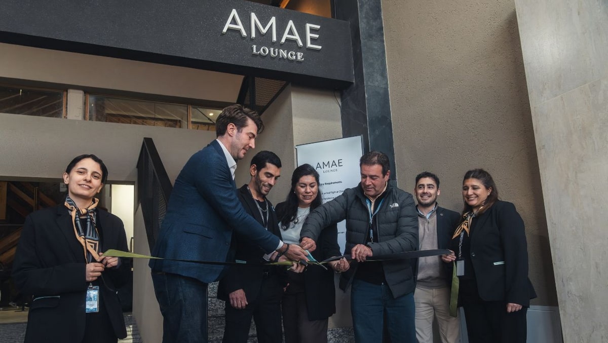 people standing outside the lounge doing a ribbon cutting for the new AMAE Lounge.