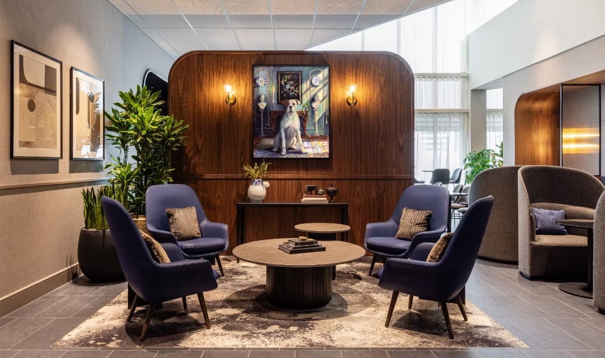central seating area with chairs, tables, and art.