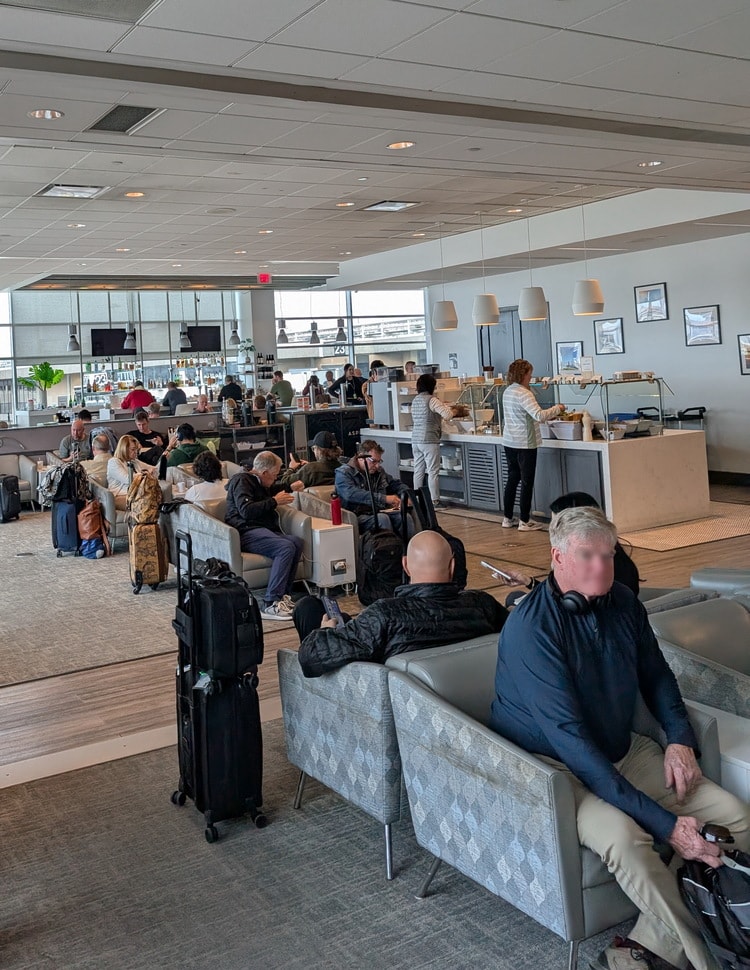 relaxation area with chairs and small side tables, and charging plugs.