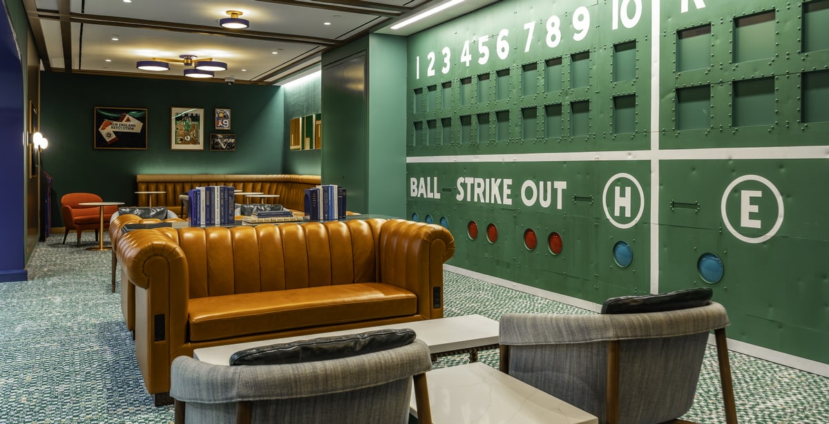The Dugout area, with sofas, and relaxing seating. Baseball theme on the walls.