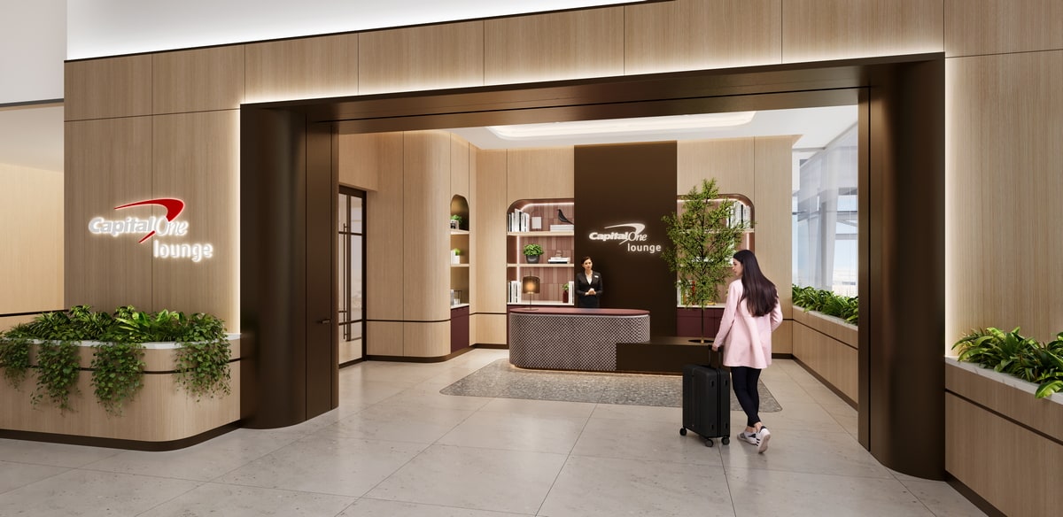Rendering of the Captial One CLT lounge entrance, with a person walking in and front desk.
