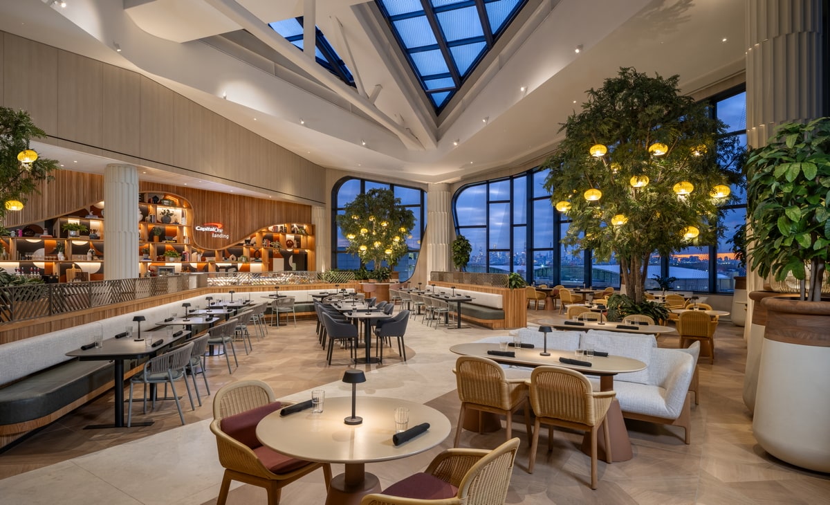 seating area with tables, and large floor-to-ceiling windows.