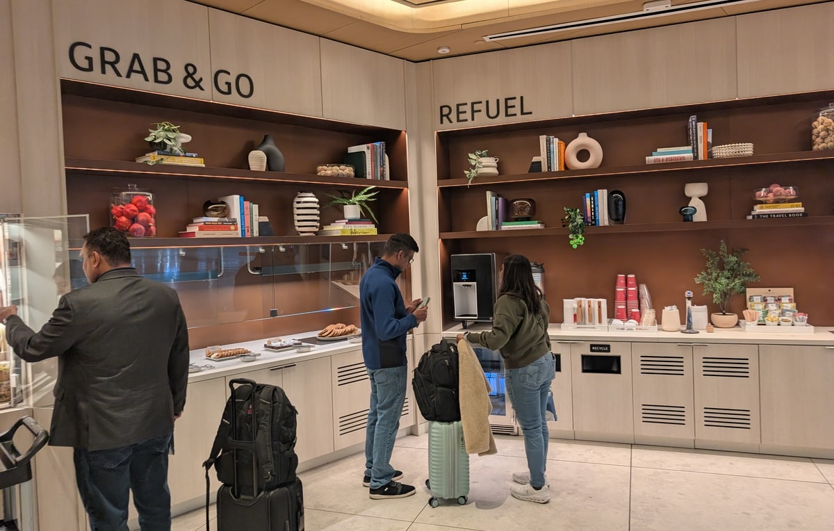grab and go area, with people standing around to get food.