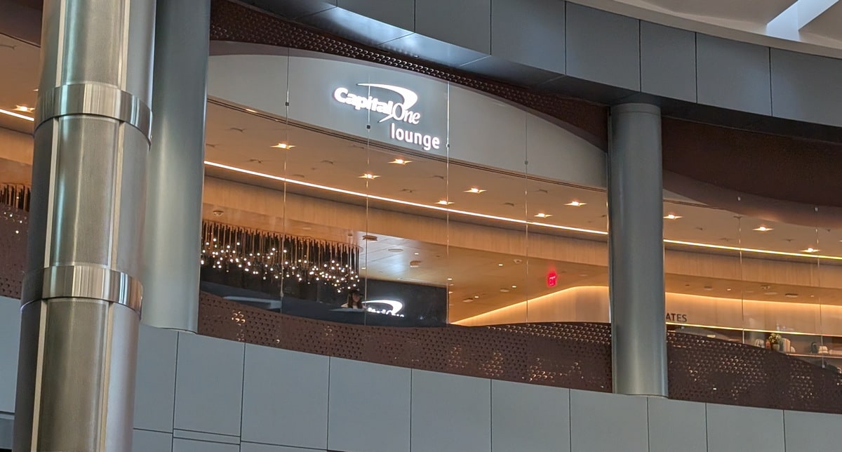 Outside of the Capital One Lounge with windows viewing the terminal.