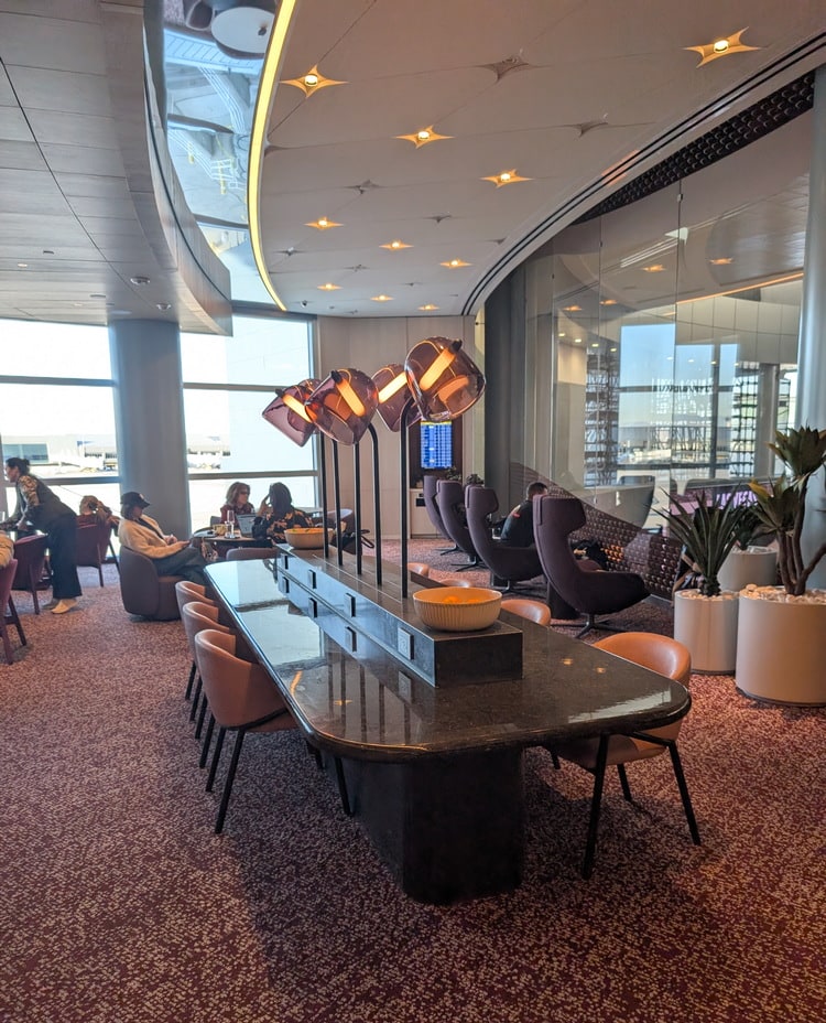 seating near window area, with tables and plants.