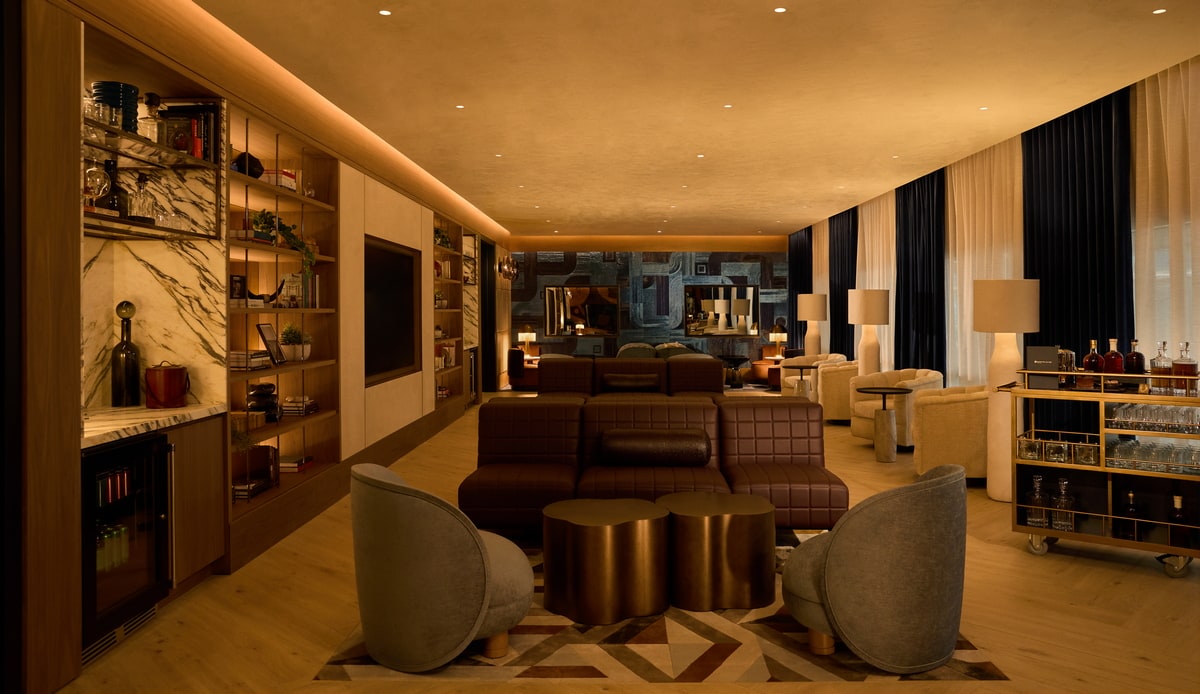a room with leather sofa, chairs, sofas, and a whiskey cart.