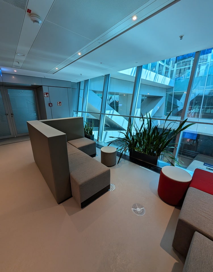 sofa in the work zone with windows and a view outside.