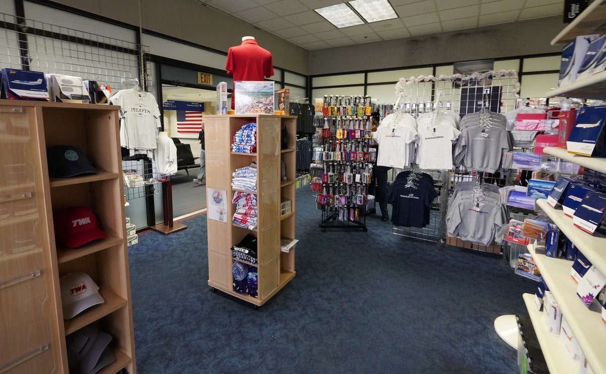 Shirts, hats, and luggage tags haning on a hook.