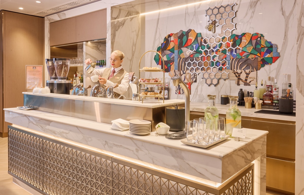 bar and coffee area with barista making coffee beverage.