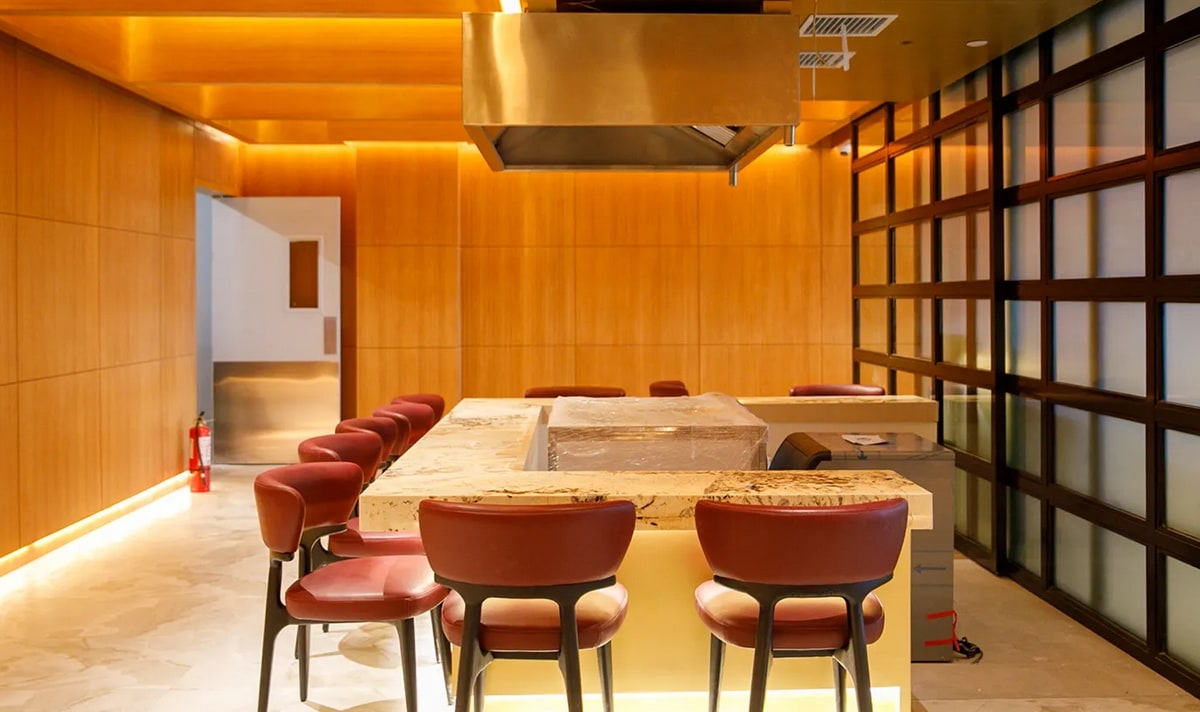teppanyaki live cooking station with seating around the cook area.