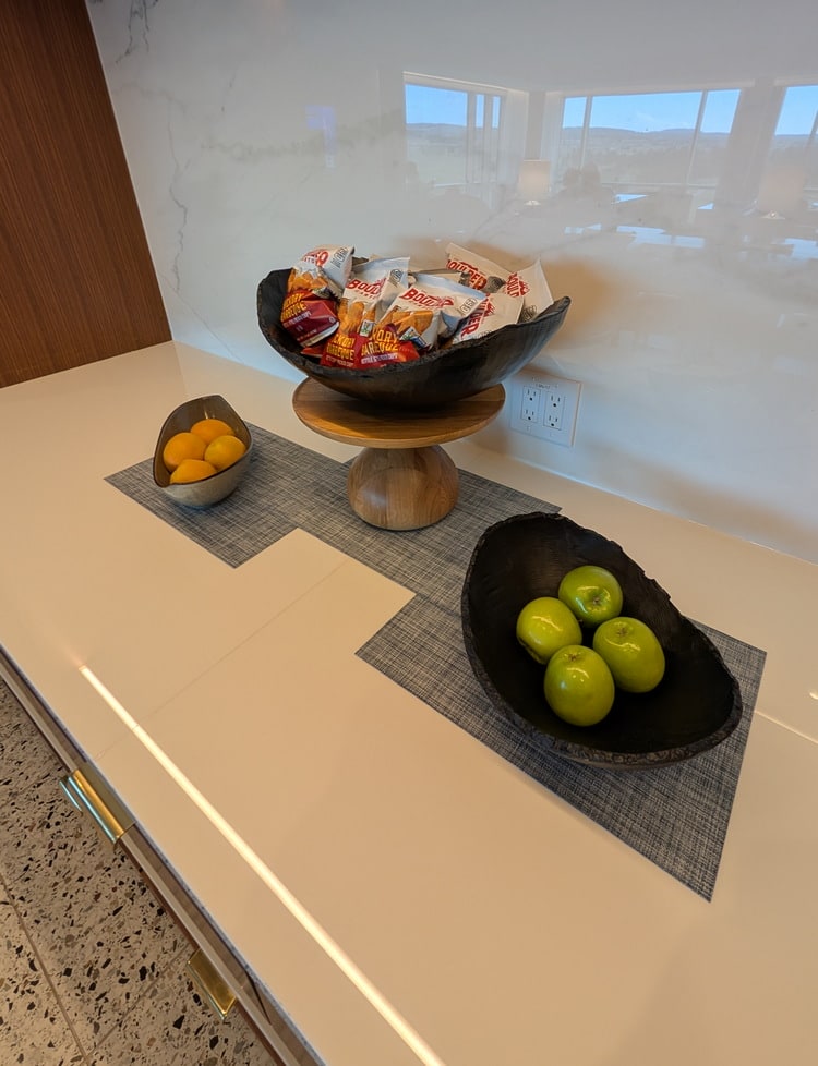 snacks including chips and apples, sitting on the serving area.