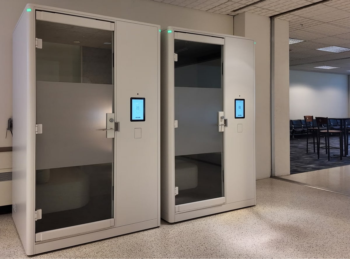 Two Jabbrrbox pods sitting in terminal area, with clear glass.