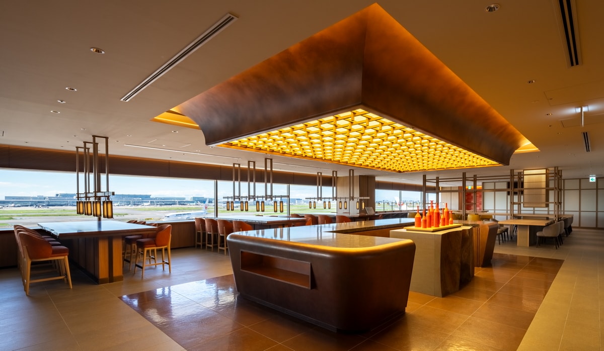 seating area with buffet and airfield views with windows in the background.