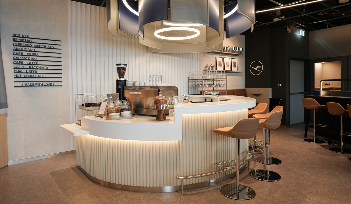 coffee bar with seating and barista.