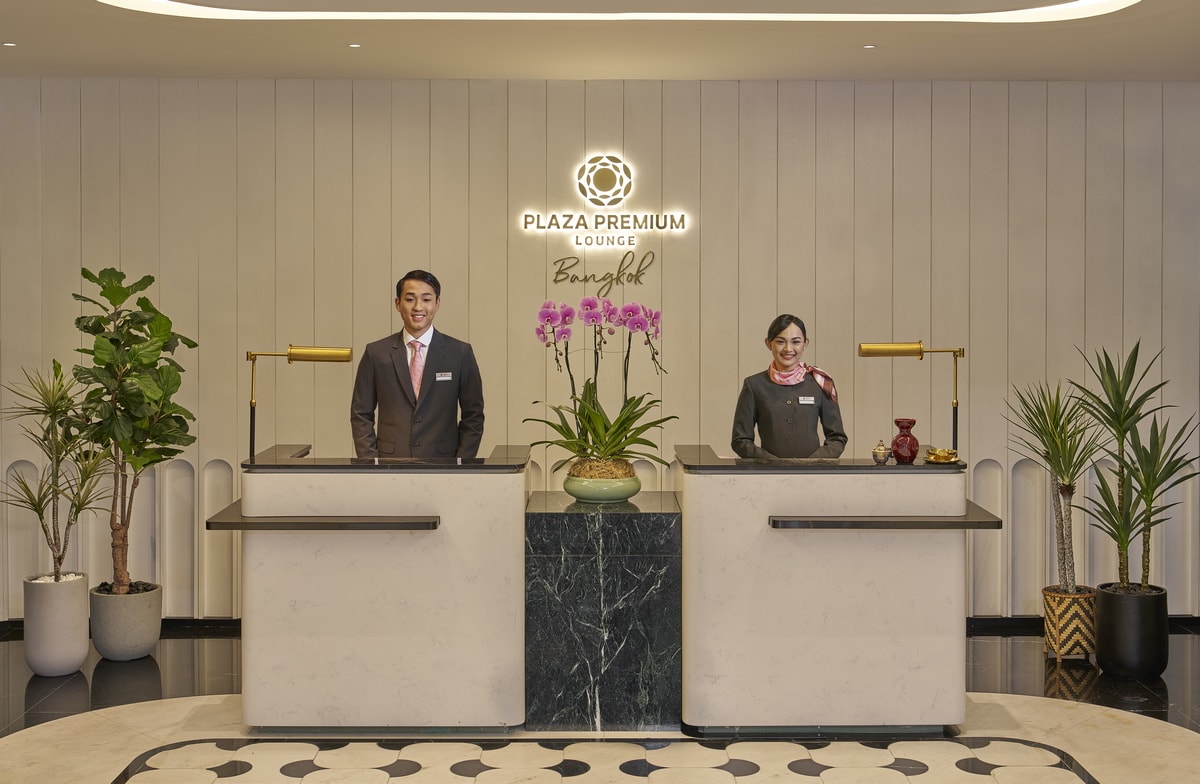 entrance to the shared lounge with two employees waiting at reception desk.
