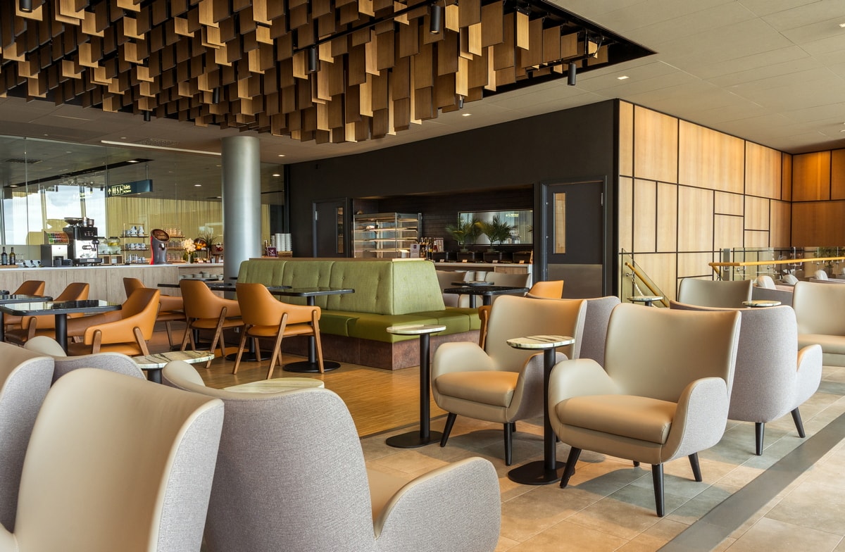 Lumi dining area with seating and tables, buffet in the background.