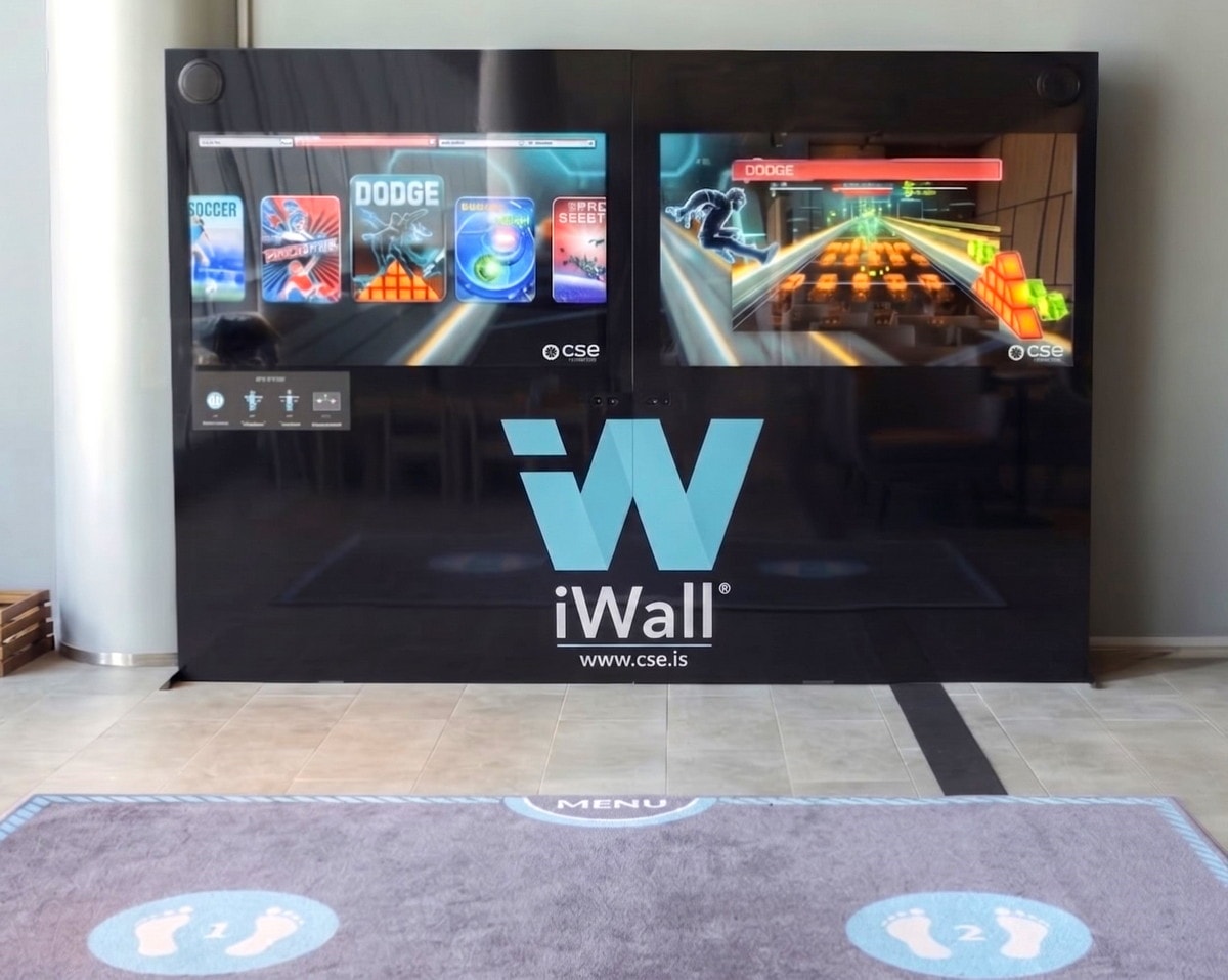 iWall gaming and exercise system with mat for standing.