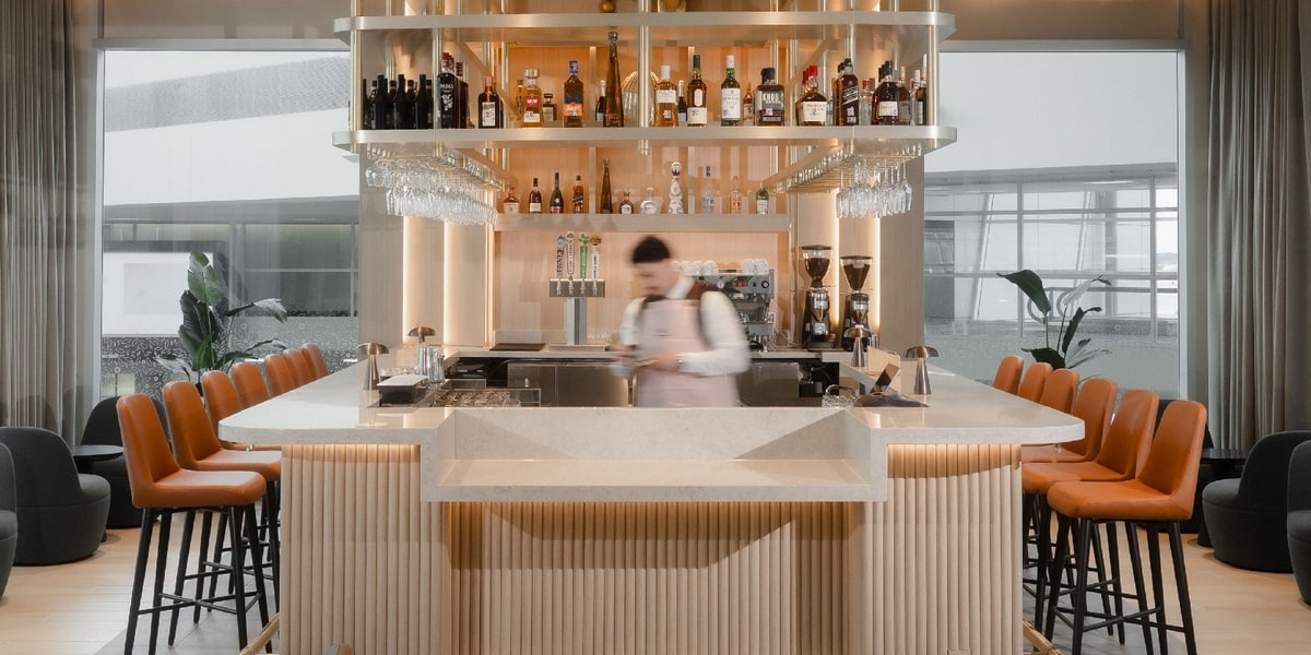 bar with seating and windows in the background.