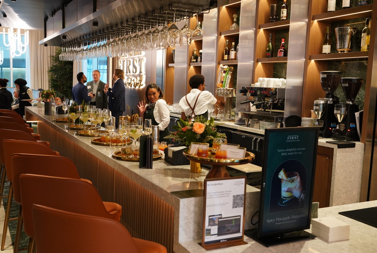 bar area with drinks on the bar and people visiting the lounge.