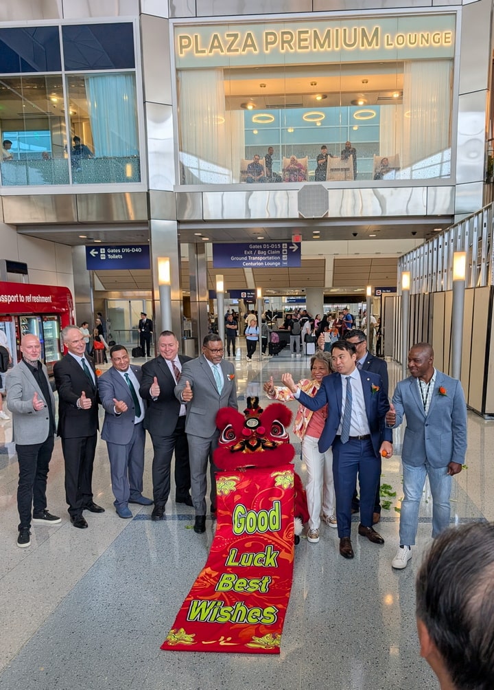 dragon and people standing nearby with their thumbs up.