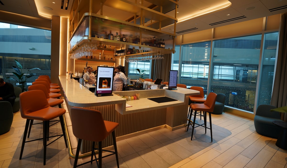 bar area with staff behind the bar and seating.