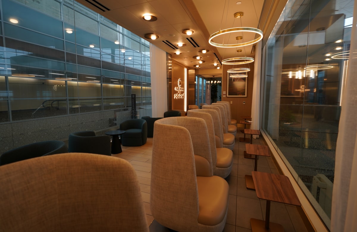 tall backed semi-private chairs with tables, looking out over the terminal.
