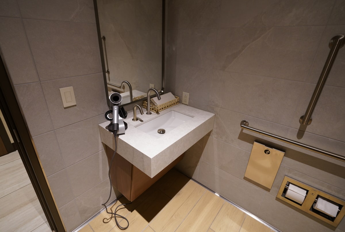 sink area with hair dryer and mirror.