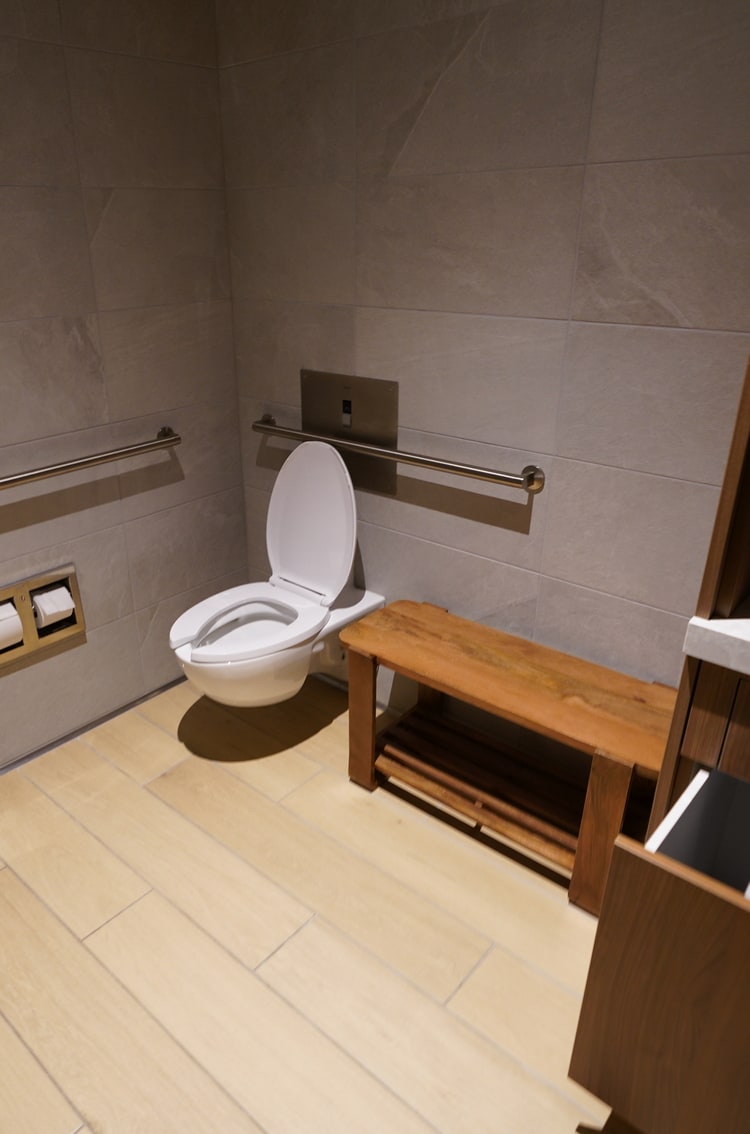 toilet and seating bench in the shower room.