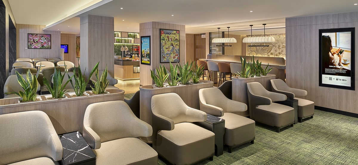 Seating area with chairs, side tables, and a buffet in the background.