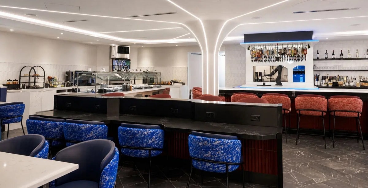 seating, tables, with a bar and food buffet in the background.