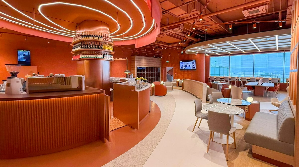 Main dining area with tables, bar, and windows in the background.