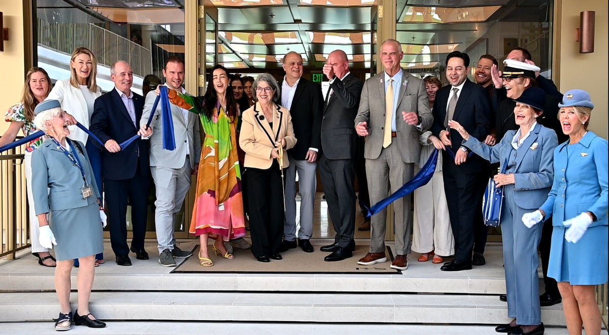Photos of many people standing at the entrance to PS just after ribbon cutting.