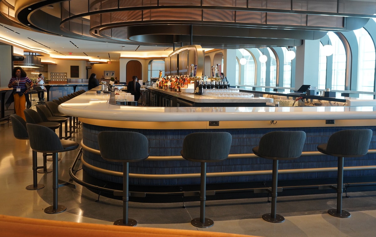 central bar with draft beer, and TVs in the middle.
