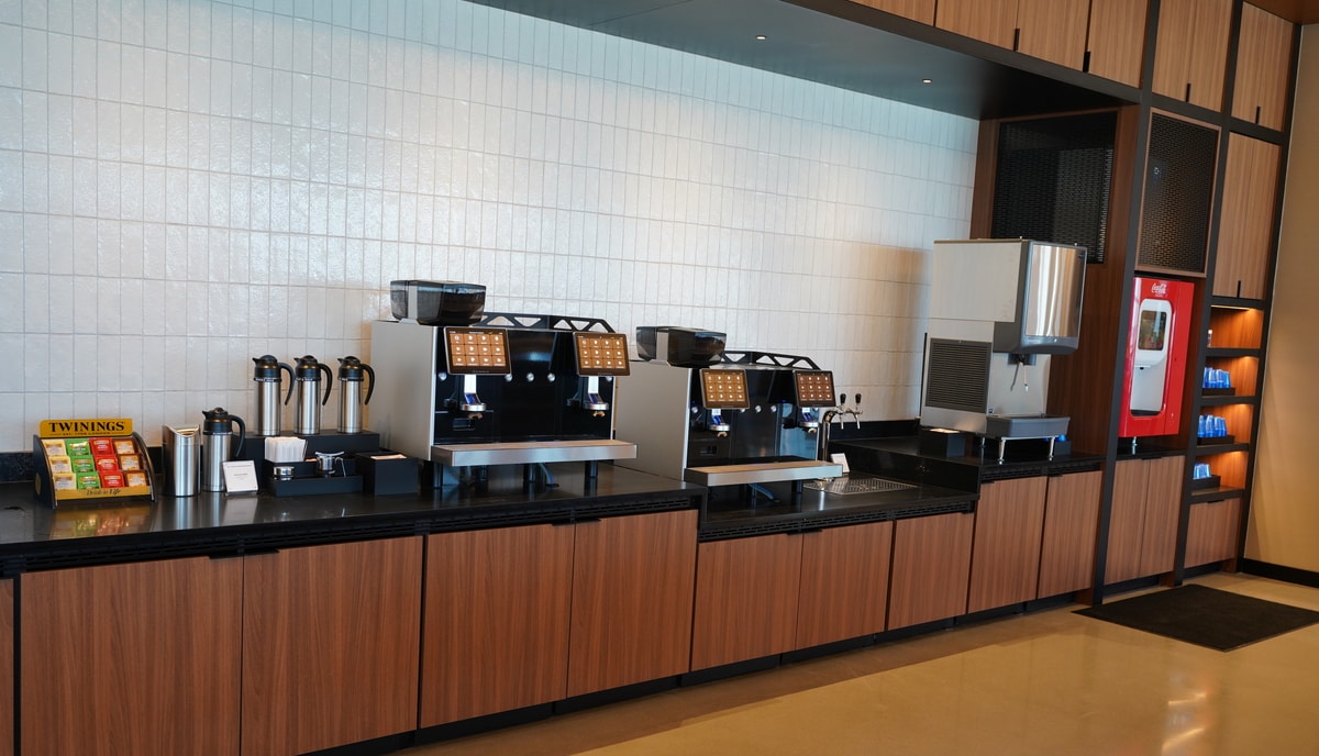 beverage station with coffee machine, tea, and a soda machine.