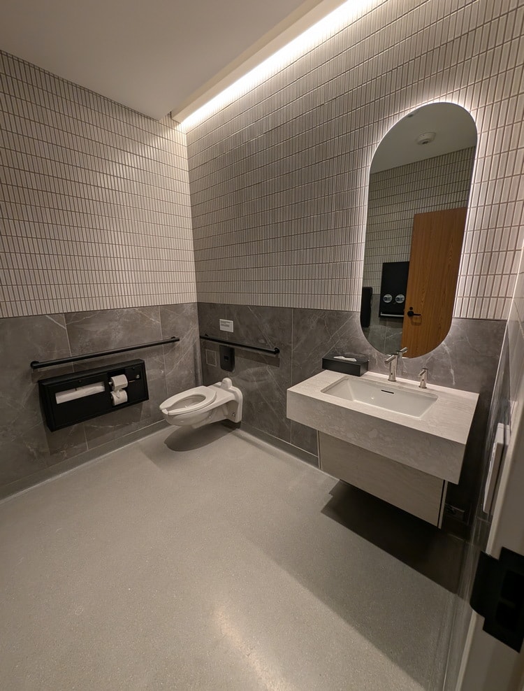 inside the family restroom showing the sink and toilet.