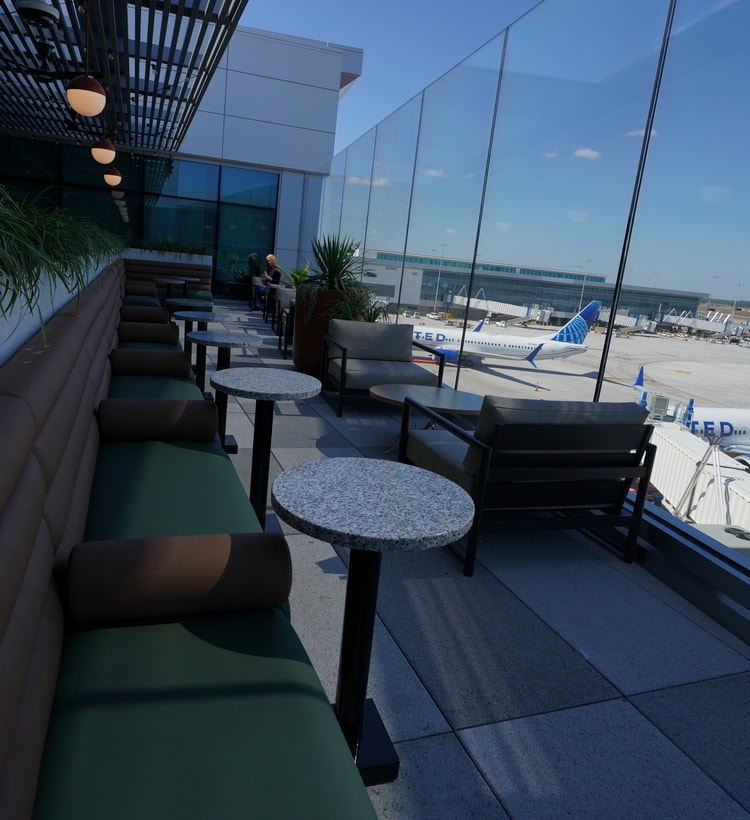 outdoor terrace with seating and airfield views.