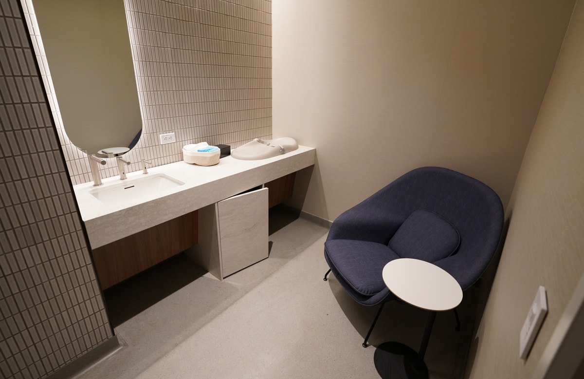 wellness room with chair and baby changing table.