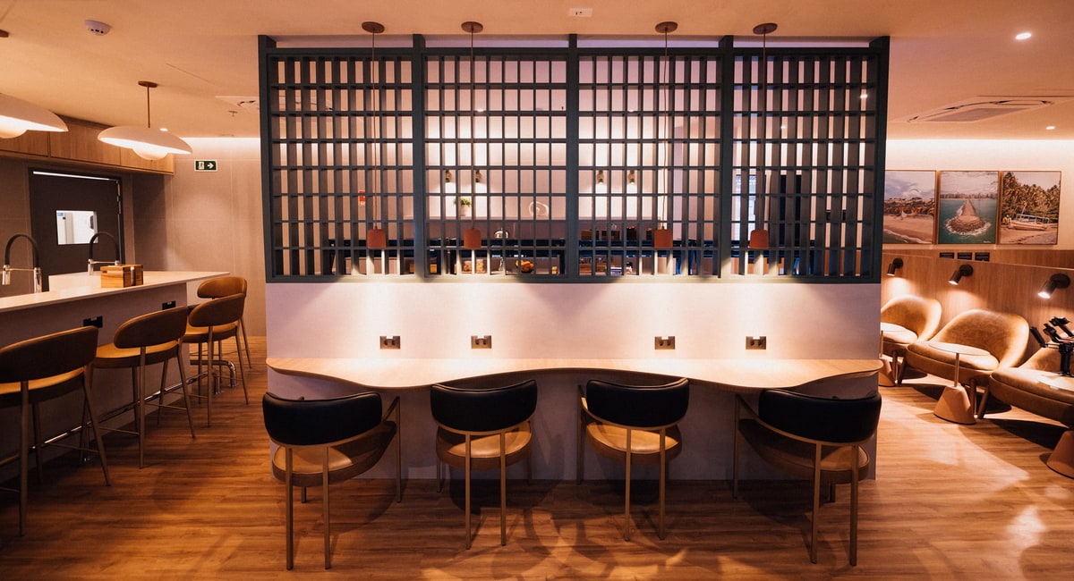 seating and bar area with coastal art on the walls.