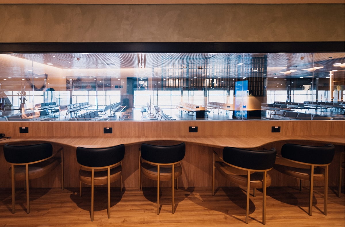 windows, with seating and tables with a view into the terminal seating area.